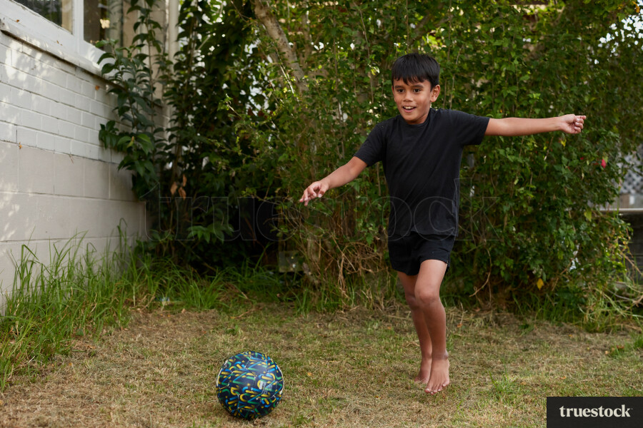Boy Playing Outside in Backyard