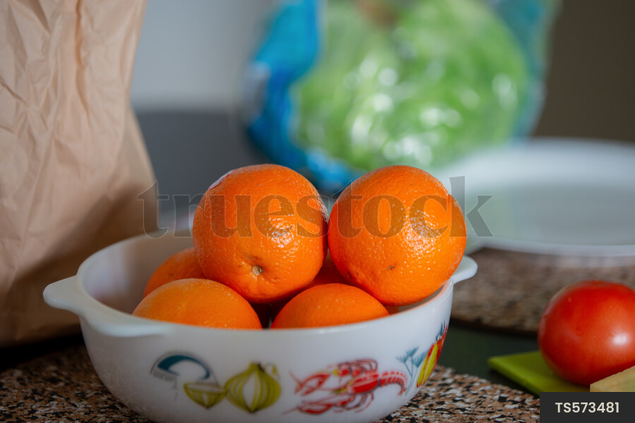Oranges in retro casserole dish on kitchen table