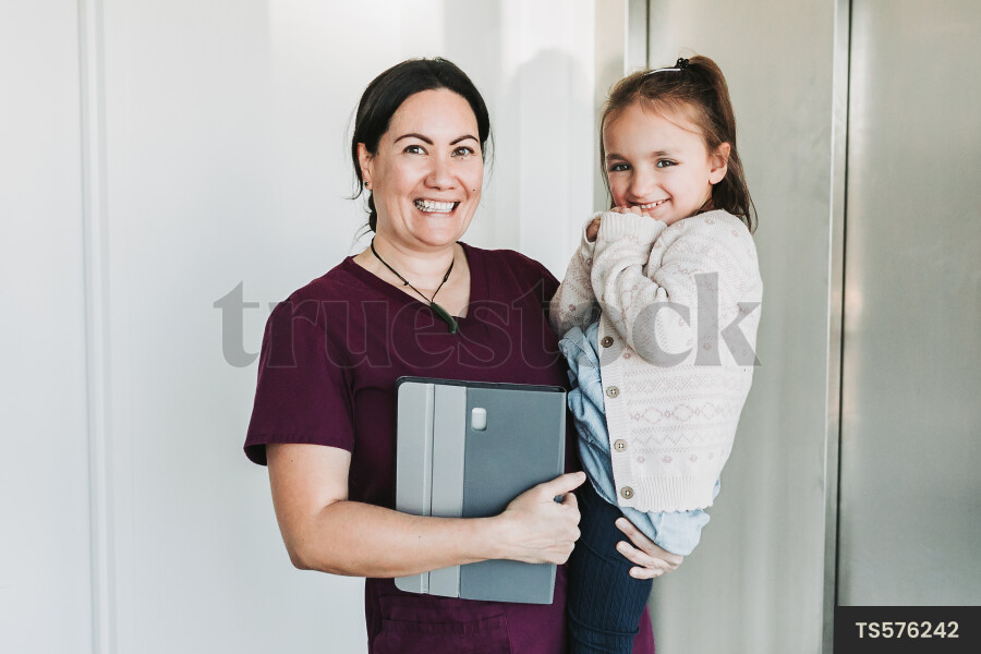 Dentist carrying patient by elevator in clinic