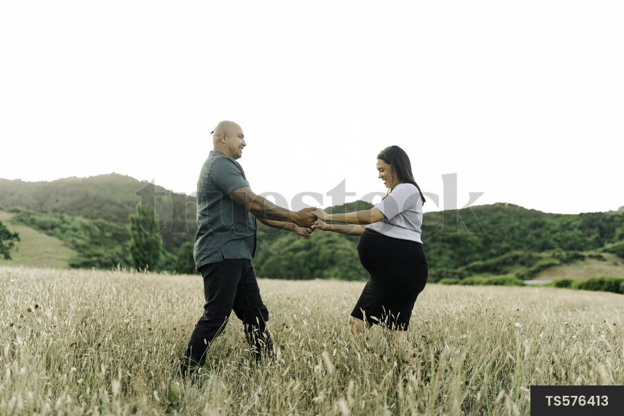 Husband and Pregnant Wife in Field