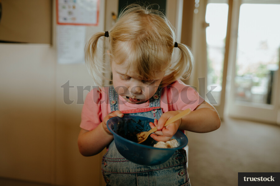 Young girl eating from a bowl