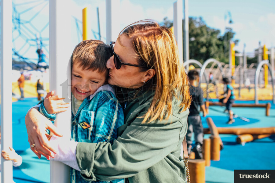 Mother Hugging Son on the Playground