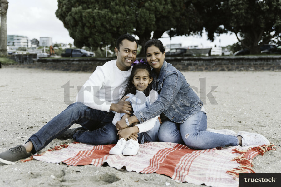 Family Portrait on Picnic Blanket at Beach