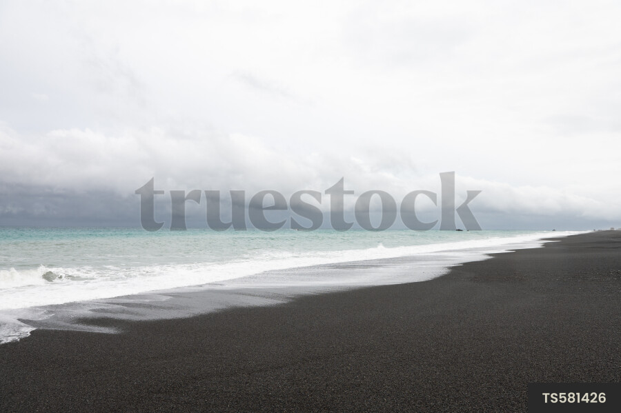 Scenic landscape of beach under clouds