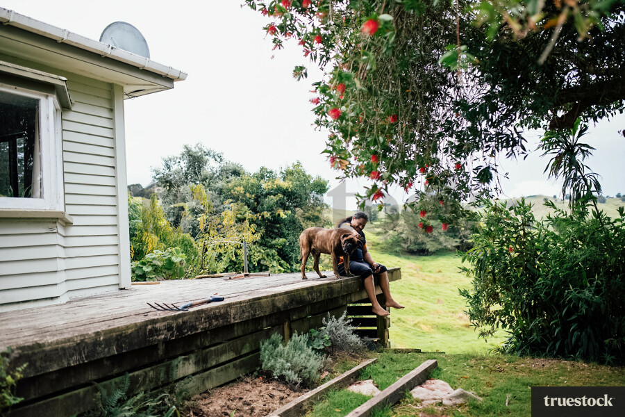 Man Sitting on the Deck with his Dog