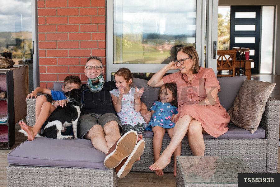 Man and woman sitting with their grandchildren