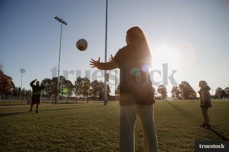 Dad Playing Catch with his Daughters