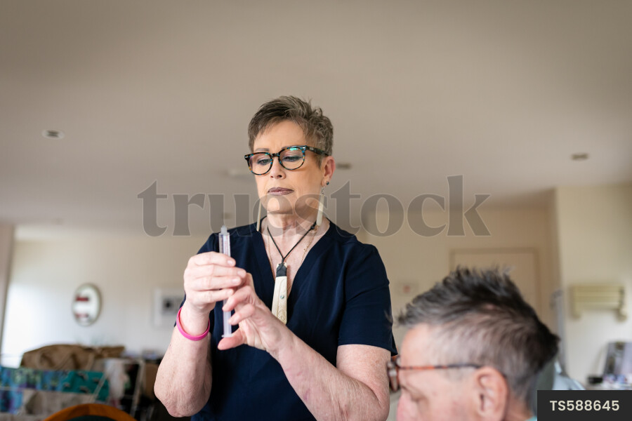 Health carer giving medicine to patient with neck brace