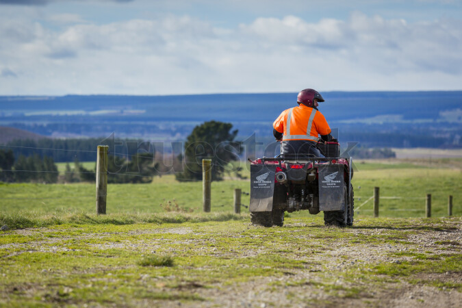 Farmer riding Quad Bike