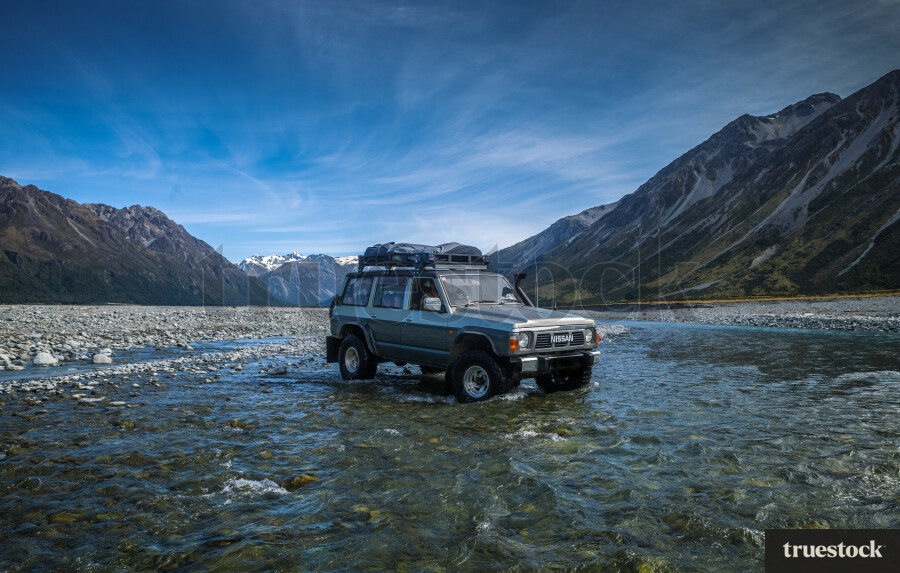 Off-roading in a 4WD through a riverbed in the countryside