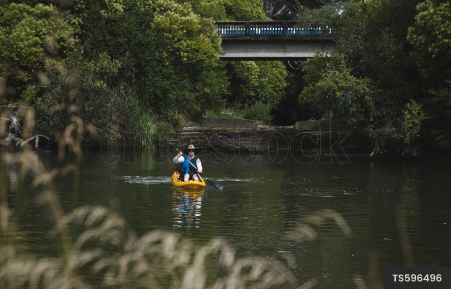 Woman kayaking on river