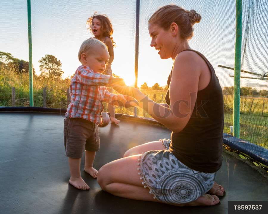Mother and Kids on Trampoline