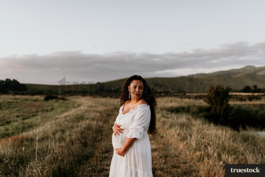 Woman Standing in Field for Maternity Shoot