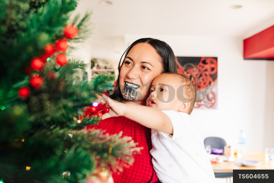 Mother and Kids Decorate Christmas Tree