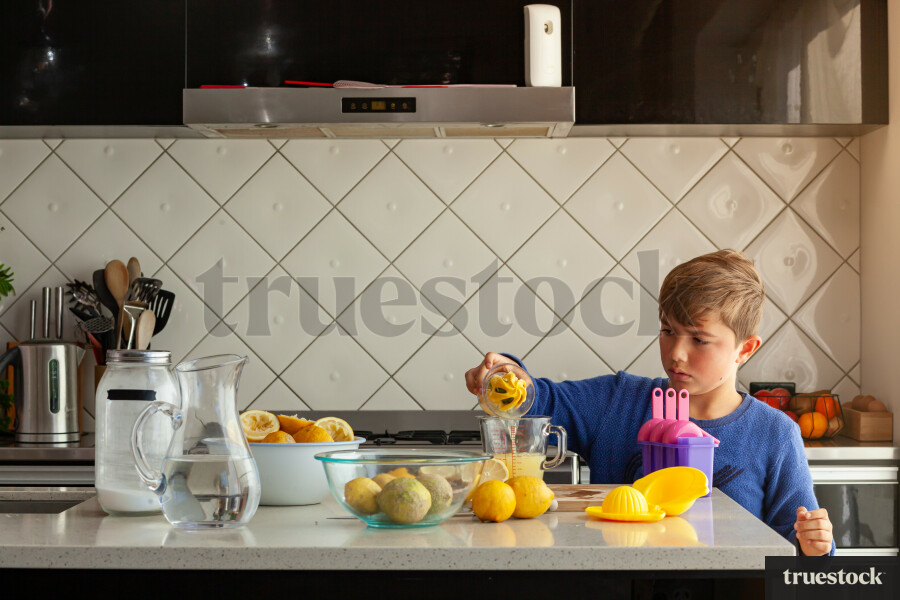 Young children making lemondade