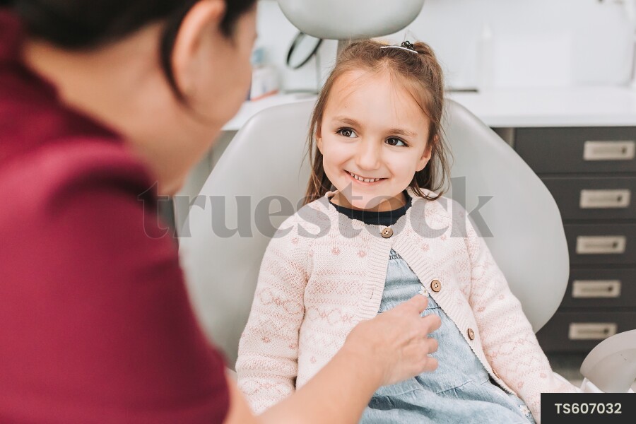 Dentist talking with patient in dental clinic