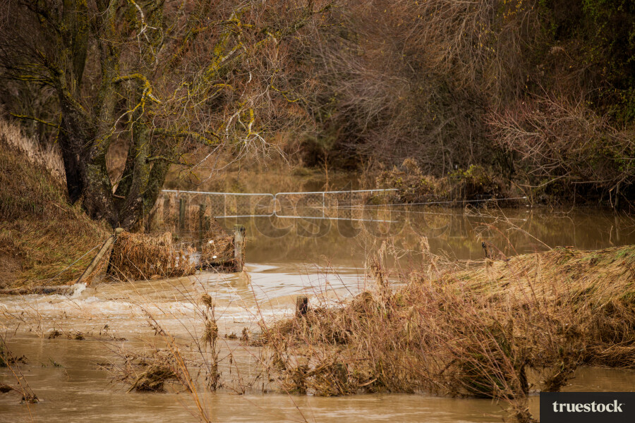Rising river water and debris from flooding
