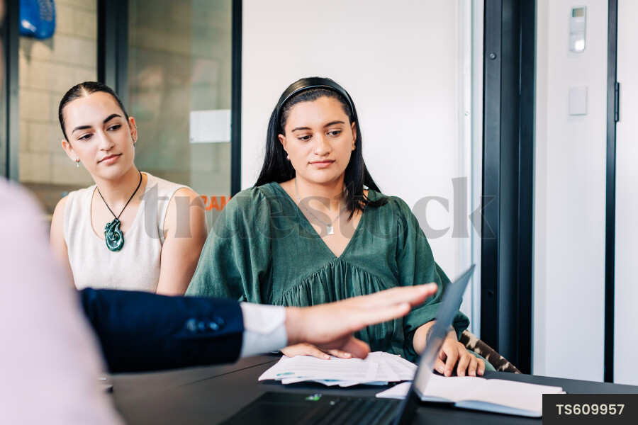 Businesspeople gesturing during meeting in boardroom