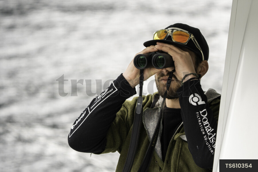 Man Looking Through Binoculars