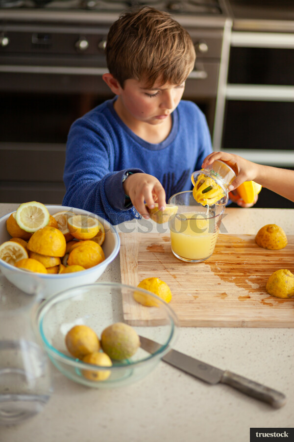 Young children making lemondade