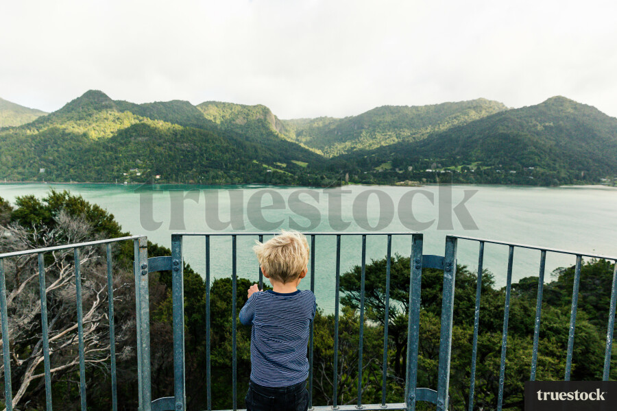 Young Boy Looking out at Harbour