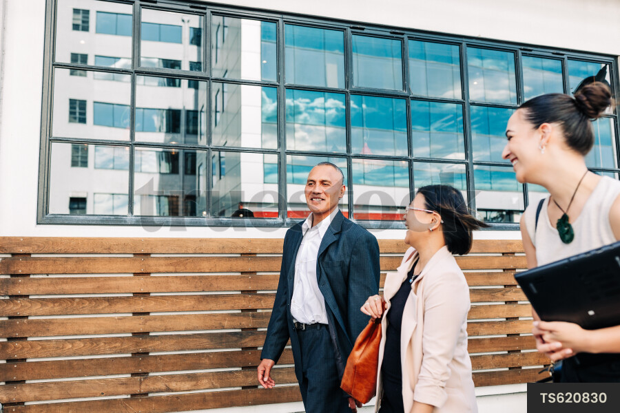 Businesspeople walking on city street
