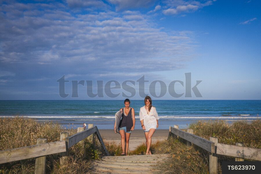 Women With Surf Board Entering Beach
