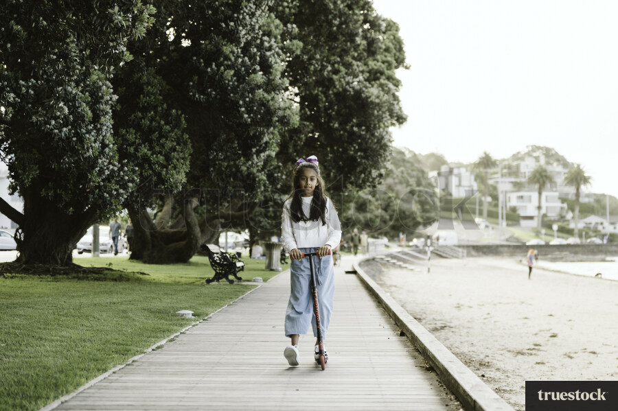 Young Girl Riding on Scooter