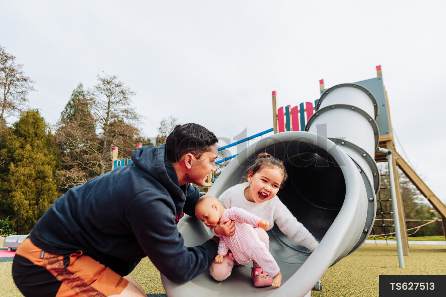 Young Girl on Slide at Park
