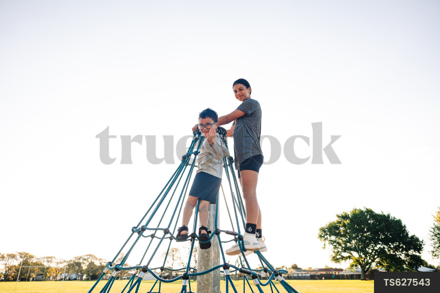 Children playing on jungle gym at park