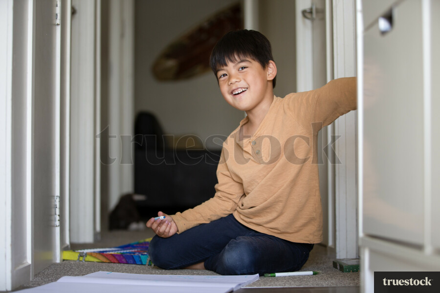 Young Boy Drawing in Hallway