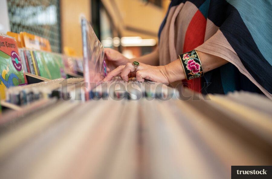 Woman Selecting Book in Library