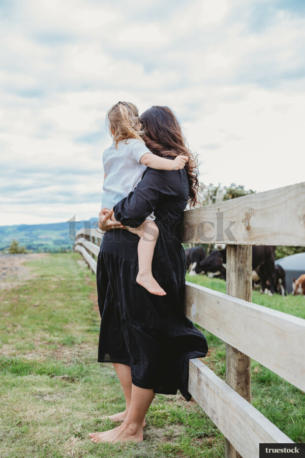 Mother hugging daughter