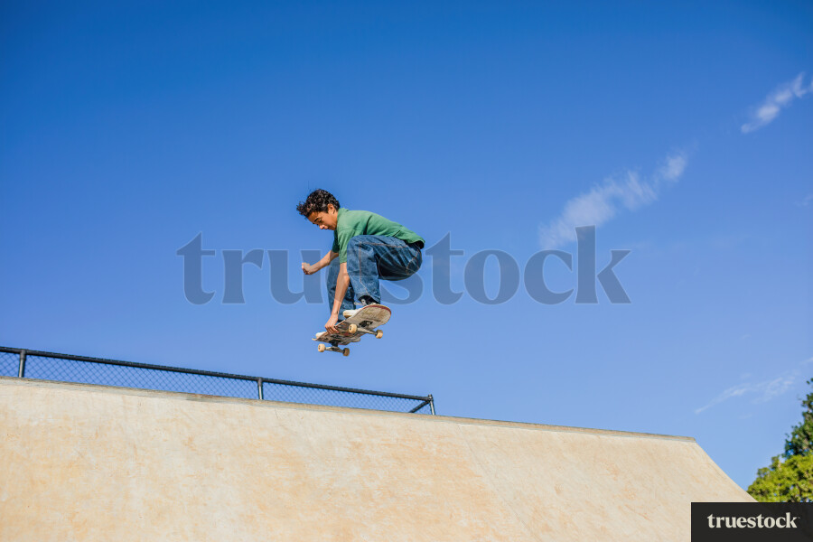 Young Boy Mid-air on Skateboard