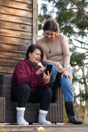 Family Using Phone on Deck
