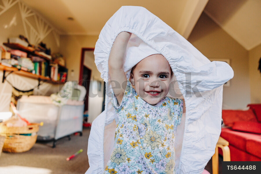 Young Toddler Playing With Sheet