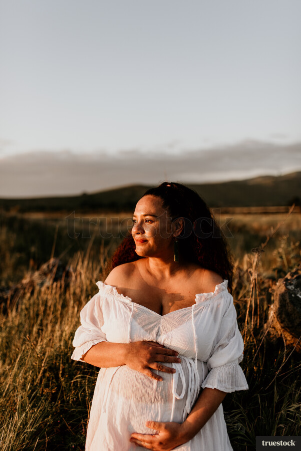 Woman Standing in Field for Maternity Shoot