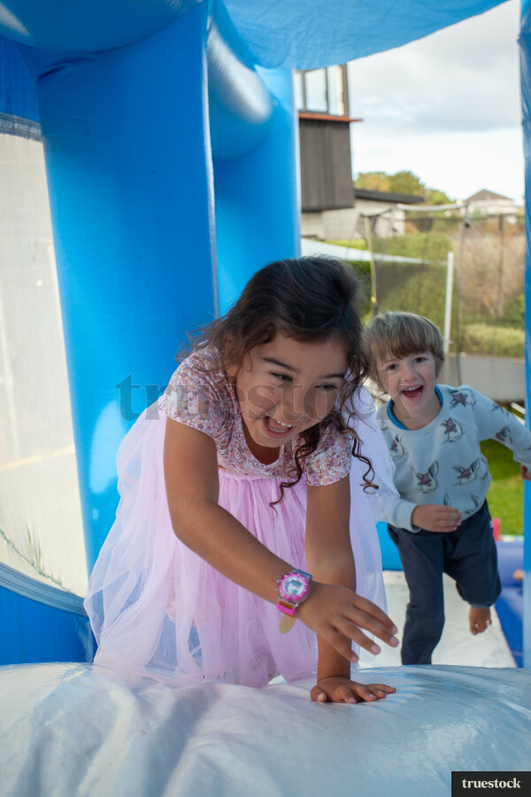 Children climbing and bouncing in the inflatable bouncy castle