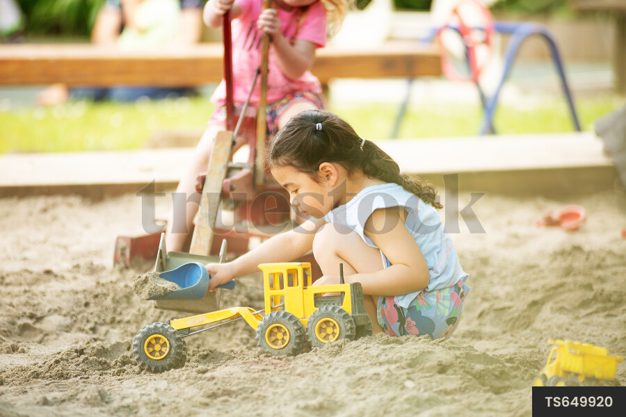Girls playing in sandpit