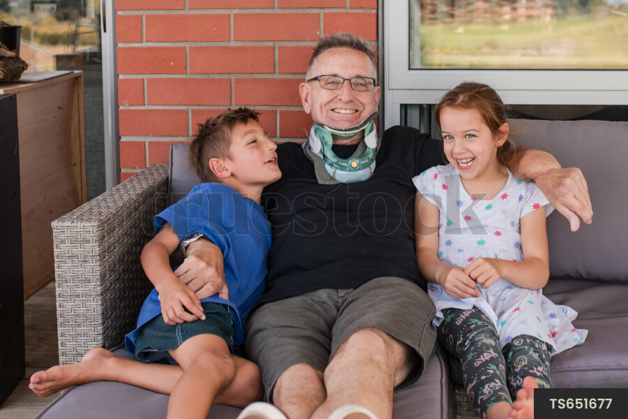 Man sitting with his grandchildren