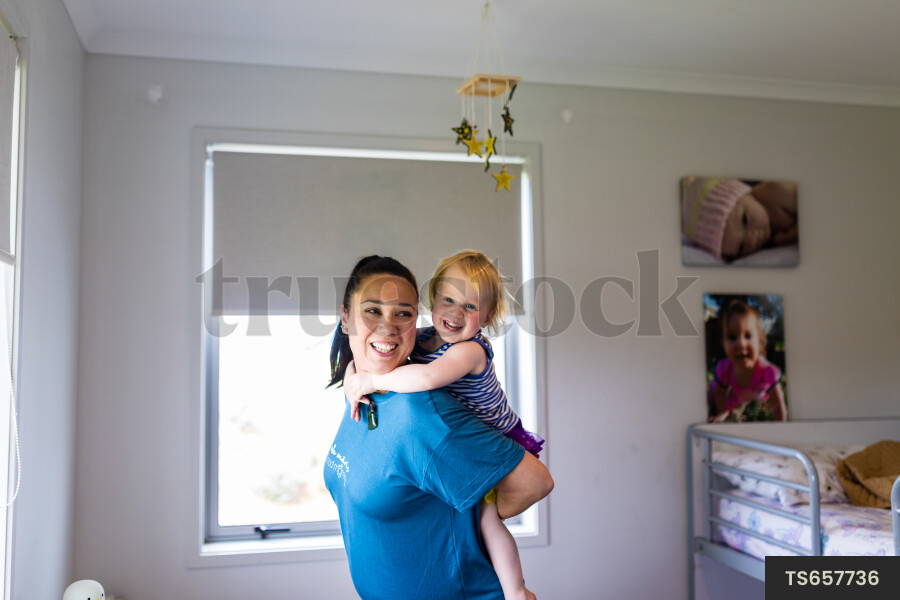 Mother Giving Daughter Piggyback