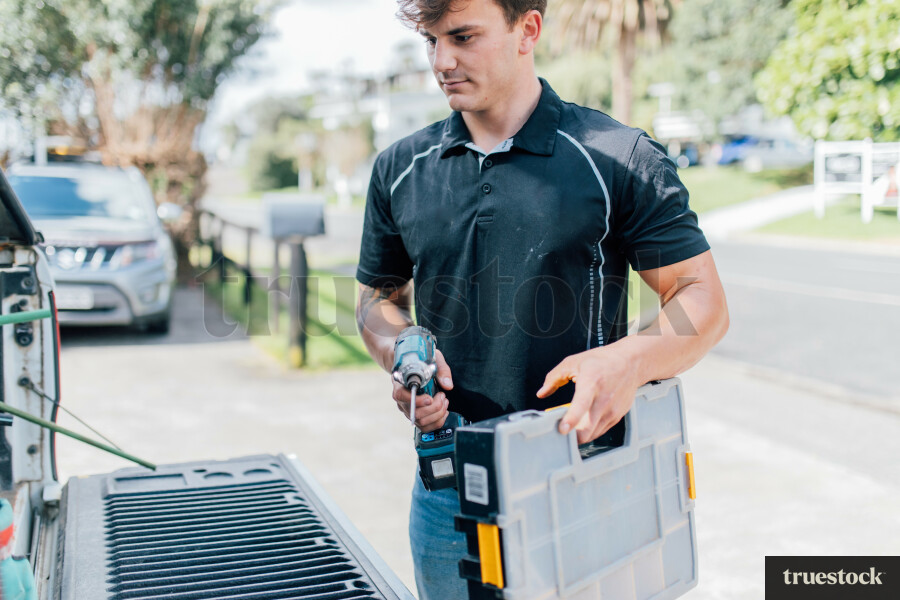 Tradie Grabbing Tools From Truck