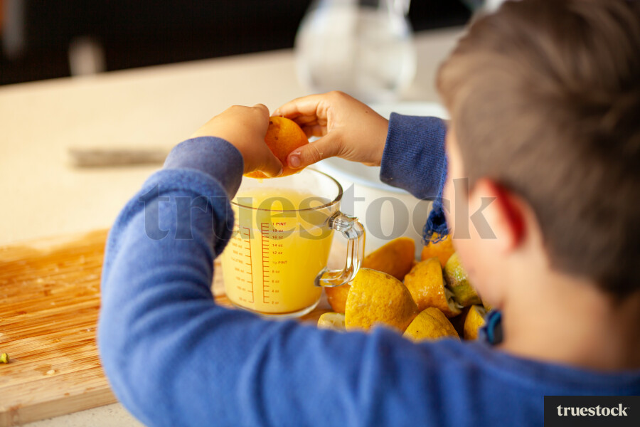 Young children making lemondade