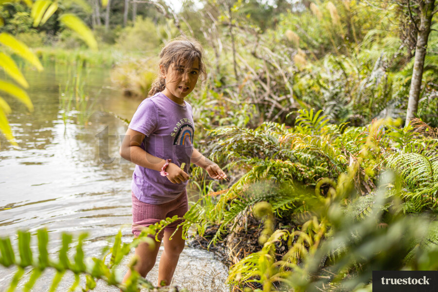 Young Girl Standing in River