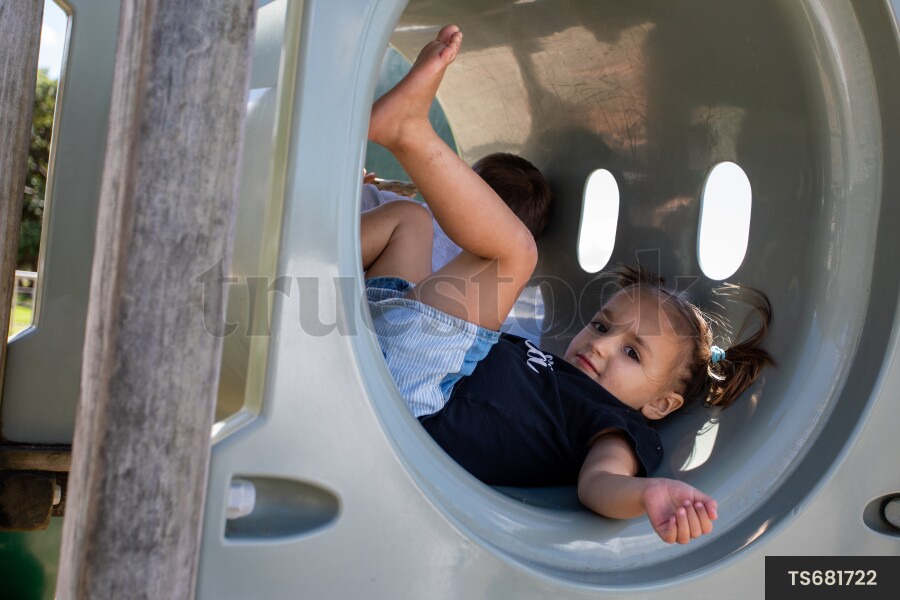 Young Girl in Tunnel on Playground
