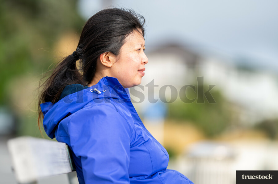Chinese woman sitting on bench