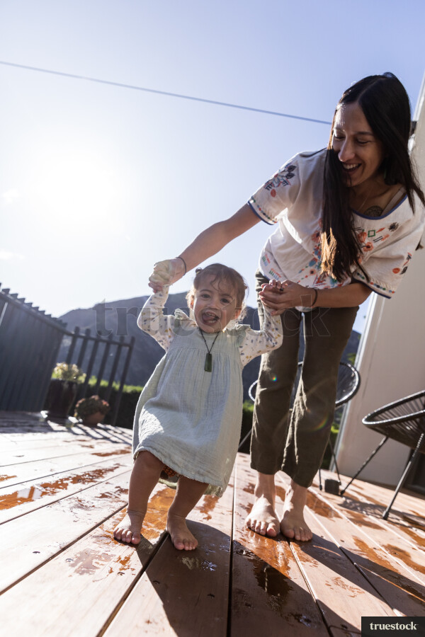 Young Girl Playing With Toy on Deck