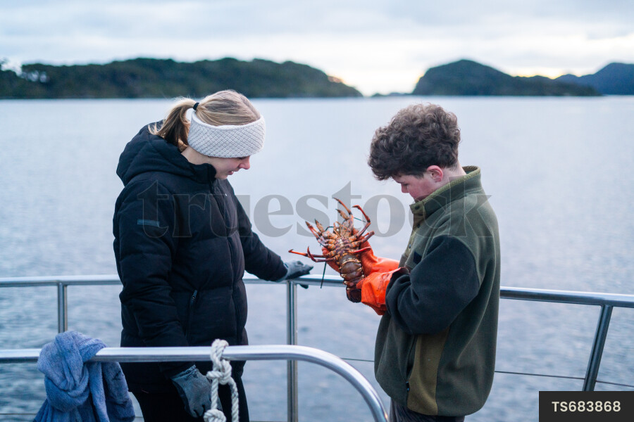 Boy with crayfish on boat