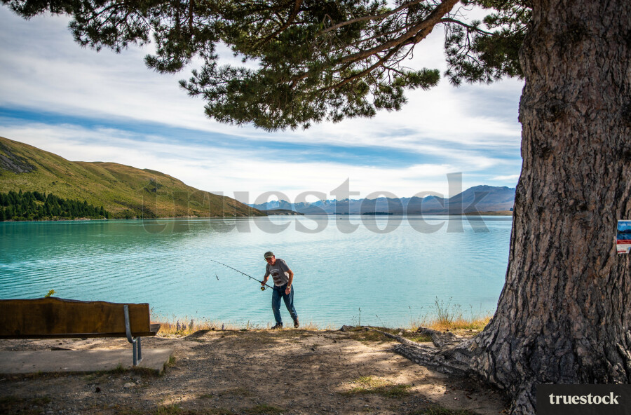 Man fishing at Lake Tekapo