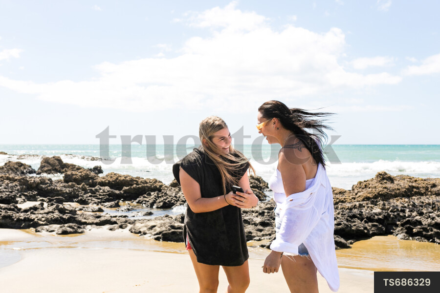 Friends taking selfies on beach